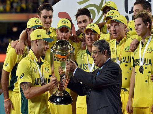 ICC chairman Narayanaswami Srinivasan (R) presents the trophy of the 2015 Cricket World Cup to Australian team Michael Clarke (L) after his team's victory against New Zealand during their 2015 Cricket World Cup final in Melbourne on March 29, 2015. AFP photo