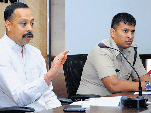 City Police Commissioner S Murugan speaks at SC/ST monthly grievancesmeeting at Police Commissioner's office in ||||||||||||||||||||||||||||||||||||||||||||||| Mangaluru on Sunday. DCP Vishnuvardhan (Crime and Traffic) looks on. DH PHOTO