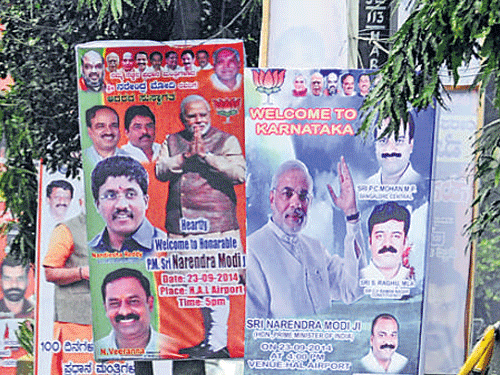 These flex boards were put up during Prime Minister Narendra Modi's previous visit to the City. DH FILE PHOTO