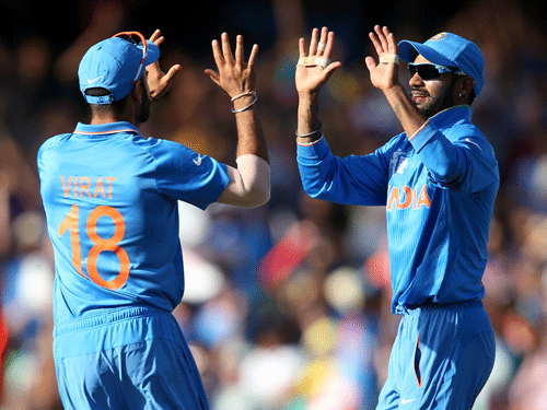 India's Virat Kohli, left, is congratulated by teammate Shikhar Dhawan after taking a catch to dismiss Australia's Aaron Finch during their Cricket World Cup semifinal in Sydney, Australia, Thursday, March 26, 2015. AP File Photo