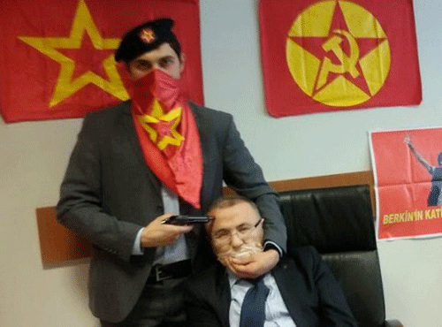Turkish Marxist-Leninist left wing organisation, the DHKP-C, shows an alleged millitant from the DHKP-C holding a gun to the head of prosecutor Mehmet Selim Kiraz in Istanbul on March 31, 2015. AFP file photo