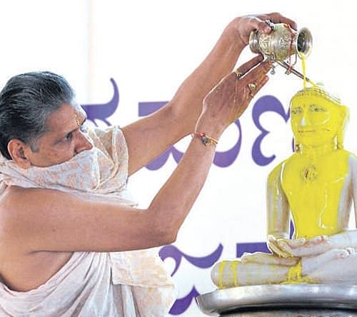 A priest performs 'abhishek' to an idol of Bhagawan Mahaveer on the occasion of Mahaveer Jayanti organised by the Jain Yuva Sangathan in the City on Thursday. DH PHOTO