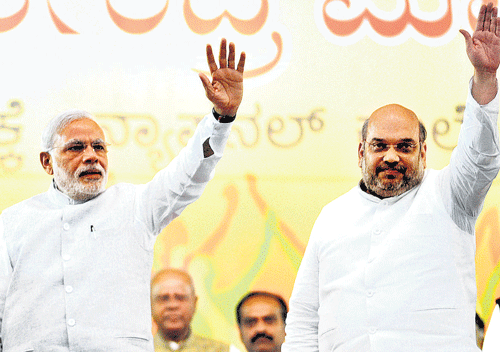 LEADERS TO THE FORE: Prime Minister NarendraModi and BJPnational presidentAmit Shah wave at the crowdat a public rally at theNational College Grounds at Basavanagudi in Bengaluru on Friday. DH PHOTO/SRIKANTA SHARMA R