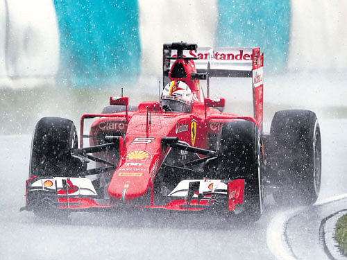 reigning in rain Sebastian Vettel dazzled in tough conditions at the Malaysian GP to notch his first win for Ferrari. AFP