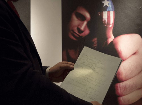 Christie's curator Tom Lecky holds the original manuscript for singer Don McLean's 'American Pie' at Christie's auction house in New York. Reuters file photo