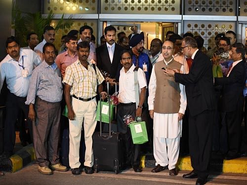 safe return:  Pakistan's High Commissioner to India Abdul Basit with Indians evacuated from Yemen by a Pakistan Navy ship, on their arrival at the IGI Airport in New Delhi on Wednesday. pti photo