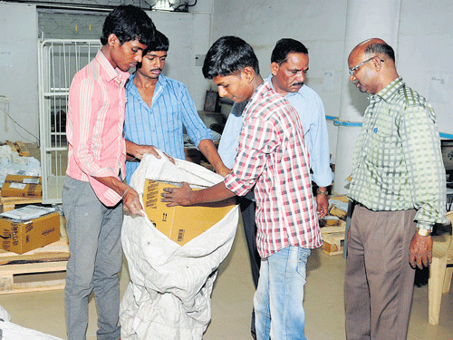 Postal department personnel ready Amazon's consignments for despatch across Bengaluru. DH PHOTO