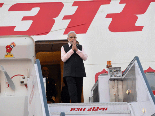 Prime Minister Narendra Modi upon arrival after a three nation tour at Palam Airport in New Delhi on Saturday. PTI Photo