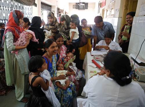 Indian women wait to get their infants immunized as part of Mission Indradhanush immunization drive at a government hospital in Allahabad. AP file photo