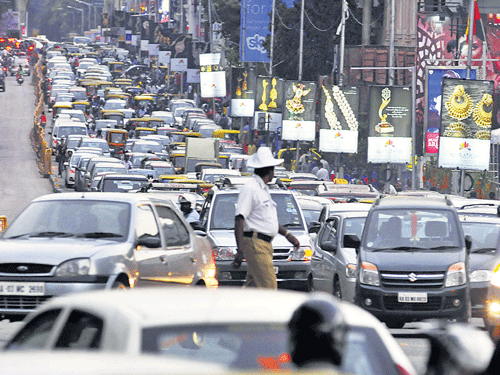 stuck in the middle Traffic was chock-a-block on MG Road and many other parts of the City, thanks to the IPL match on Wednesday. DH Photo by BK Janardhan