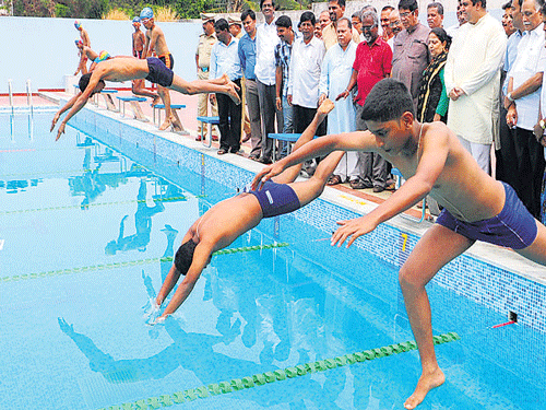 Students jump into the pool as Sports Minister K&#8200;Abhyachandra Jain, Rajya Sabha MP&#8200;Oscar Fernandes and MLA&#8200;Pramodh Madhwaraj among others look on, after the inauguration of the swimming pool in Udupi on Saturday.