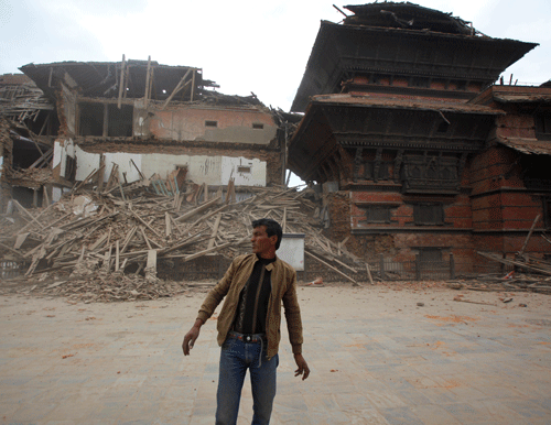 A person walks past a collapsed building in Kathmandu. AP photo