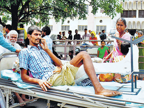 Patient pacifies relative over phone after tremors in Lucknow on Saturday.PTI