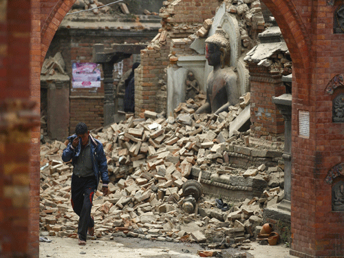A man cries as he walks on the street while passing through a damaged statue of Lord Buddha a day after an earthquake in Bhaktapur, Nepal April 26, 2015. Rescuers dug with their bare hands and bodies piled up in Nepal on Sunday after the earthquake devastated the heavily crowded Kathmandu valley, killing at least 1,900, and triggered a deadly avalanche on Mount Everest. Reuters Photo.