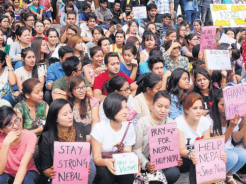 Nepalese residing in the City observe a Black Day near Town Hall to pray for the earthquake victims, on Sunday. DH&#8200;photo