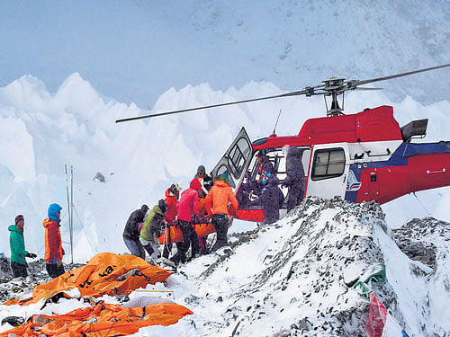 An injured person is being helped onto a helicopter at Everest Base Camp. AP