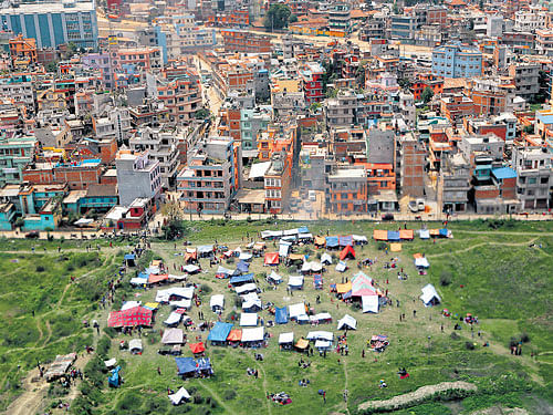 Tents are seen from an airplane window in an open field next to Tribhuvan International Airport on Sunday. AP