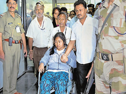 Manashi Adhikari, who was injured in the quake, arrives at Guwahati airport on Monday. Her mother died when the hotel in which they were staying in Kathmandu collapsed. AP