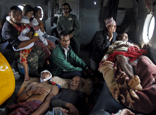 Victims of Saturday's earthquake rest inside an Indian Air Force helicopter as they are evacuated from Trishuli Bazar to the airport in Kathmandu, Nepal. Reuters file photo