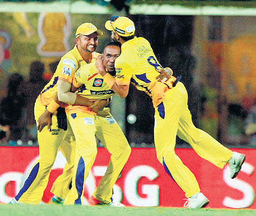 party time: Chennai Super Kings' Dwayne Bravo (centre) is congratulated by Suresh Raina and Ravindra Jadeja after claiming a Kolkata Knight Riders' wicket in their IPL&#8200;game in Chennai on Tuesday. BCCI