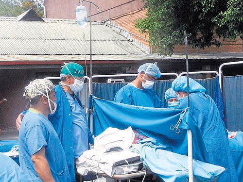 This photo, taken on Sunday, shows an outdoor emergency Caesarean Section. The operation was conducted during aftershocks when it was too dangerous to be inside the hospital. Courtesy:&#8200;Scheer Memorial Hospital