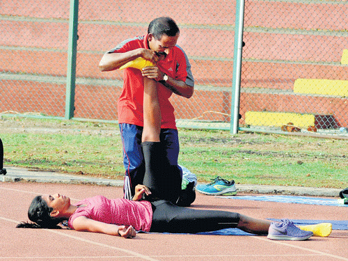 geared up: ONGC's MR Poovamma stretches during a practice session on Thursday. dh photo/ govindraj javali