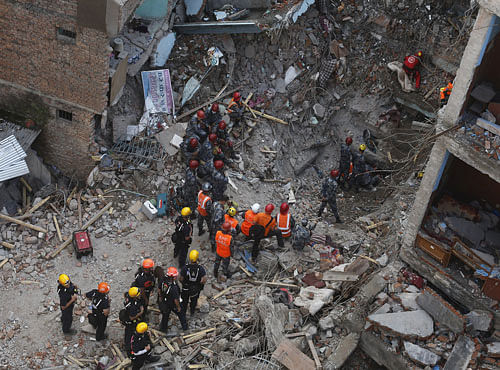 Members of a rescue team from Hungary and Nepal armed police personnel search for earthquake survivors under the debris of a collapsed building, in Kathmandu. Reuters photo