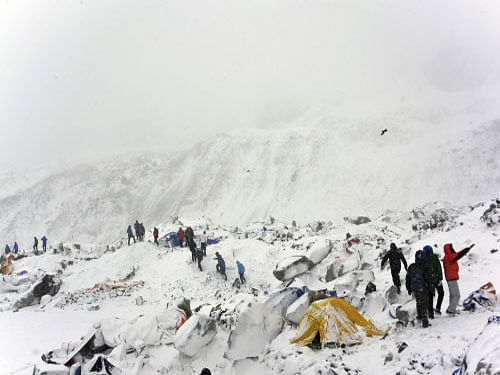 Climbers search through crushed tents for fellow climbers caught in an avalanche at a base camp on the Nepal side of Mount Everest. AP