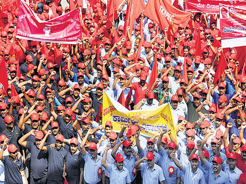 Workers take out a rally to mark May Day, in the City on Friday. DH photo