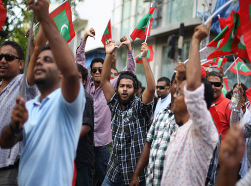 Opposition supporter shout slogans during a protest demanding Maldives President Yameen Abdul Gayoom resign and jailed ex-president Mohamed Nasheed be freed, in Male', Maldives. AP photo
