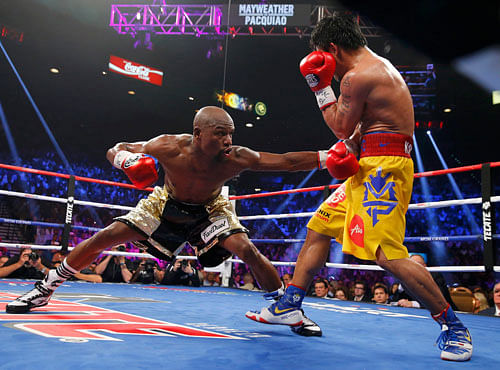 Mayweather, Jr. of the U.S. stays low against Pacquiao of the Philippines in the eighth round during their welterweight title fight in Las Vegas. Reuters photo