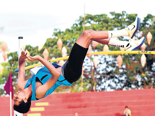 fine show: Karnataka's S Harshith leaps to the high jump gold in Mangaluru on Sunday. dh photo/ govindraj javali
