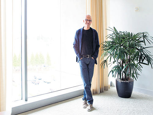 dreaming big: Satya Nadella envisions a Microsoft with fewer internal fiefdoms and more willingness to favour big bets on new technologies over protecting legacy cash cows. (inset) A researcher demonstrates efforts to improve stylus latency in the firm's Surface tablet. nyt