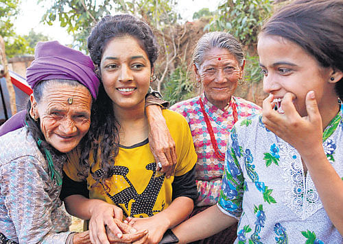 stealing a moment Loysyanri Khanal, 78,  with the young girls in their destroyed village of Pokharidanda, near the epicentre of the  earthquake, in the Gorkha district. AP