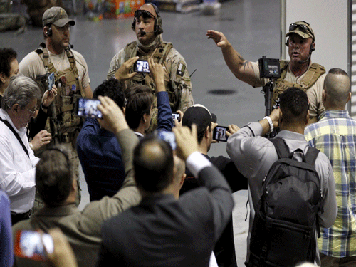 Police officers address attendees at the Muhammad Art Exhibit and Contest after they are prevented from leaving when shots were fired at the exhibit in Garland, Texas. Reuters photo