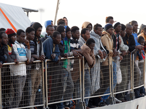 Migrants wait to disembark from the Iceland Coast Guard vessel Tyr at the Messina harbor, Sicily, southern Italy, Wednesday, May 6, 2015.  AP