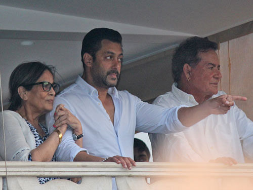 Bollywood actor Salman Khan gestures to fans from the balcony of his home, flanked by his mother Sushila Charak and father Salim Khan in Mumbai, India, Friday, May 8, 2015. A court on Friday granted bail to Khan, one of India's biggest movie stars until it hears his appeal challenging his conviction in a drunk-driving hit-and-run case more than a decade ago. AP