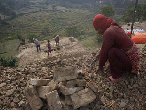 Nepalese people work to rebuild their damaged homes in Lalitpur, Nepal, Friday, May 8, 2015. The April 25 earthquake killed thousands and injured many more as it flattened mountain villages and destroyed buildings and archaeological sites in Kathmandu. AP