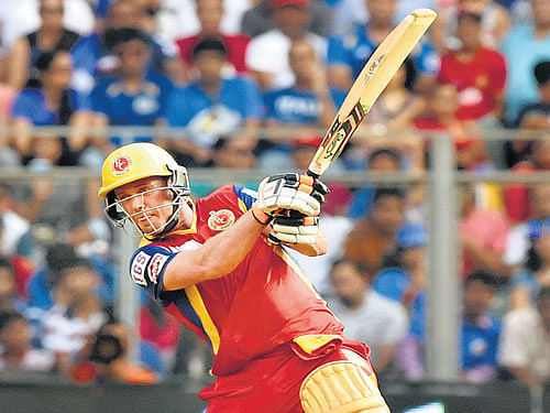In a zone: A B de Villiers smashes one to the boundary during his unbeaten 133 against Mumbai Indians on Sunday. pti