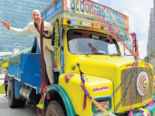 going desi: Amazon's chief executive Jeff Bezos, who invested $2 billion in the company's India unit, poses on a festooned truck in Bengaluru. Venture capital firms, hedge funds and top business executives are all vying for a piece in India's rapidly growing e-commerce market. nyt