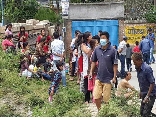 In this photo provided by the International Organization for Migration (IOM), people gather in the street after an earthquake in Kathmandu, Nepal, Tuesday, May 12, 2015. A major earthquake hit Nepal near the Chinese border between the capital of Kathmandu and Mount Everest less than three weeks after the country was devastated by a quake. AP Photo.