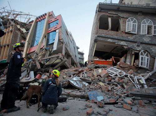 USAID rescue workers inspect the site of collapsed buildings after an earthquake in Kathmandu, Nepal, Tuesday, May 12, 2015. AP photo