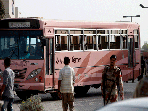 A Pakistani paramilitary trioop stands guard near a bus targeted by attackers in Karachi, Pakistan, ap photo