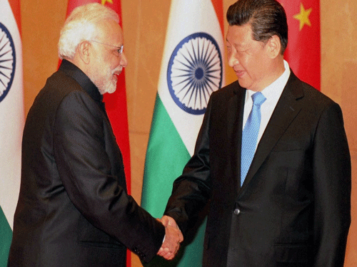 Prime Minister Narendra Modi shakes hands with Chinese President Xi Jinping during a meeting in Xi'an, Shaanxi Province, China on Thursday. PTI Photo