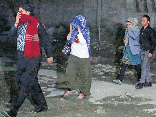 Rescued people coming out from the site of an attack in Kabul on Wednesday. REUTERS