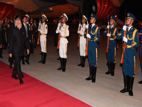 Prime Minister Narendra Modi being welcomed on his arrival at Beijing airport in China. PTI photo