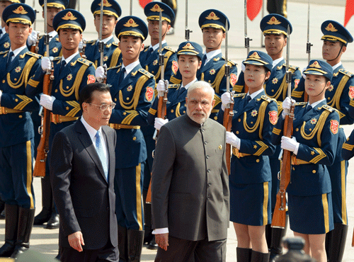 Indian Prime Minister Narendra Modi and Chinese Premier Li Keqiang review an honor guard during a welcome ceremony outside the Great Hall of the People in Beijing. Reuters photo