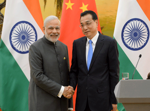 Indian Prime Minister Modi shakes hands with Chinese Premier Li during a news conference at the Great Hall of the People in Beijing. Reuters