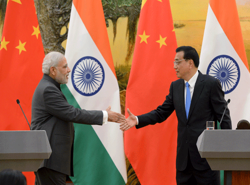 Indian Prime Minister Modi shakes hands with Chinese Premier Li during a news conference at the Great Hall of the People in Beijing. Reuters photo