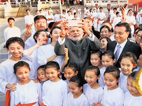 Another one for the albums: Prime Minister Narendra Modi with Chinese Premier Li Keqiang takes selfie with children during a visit to the Temple of Heaven in  Beijing on Friday. PTI